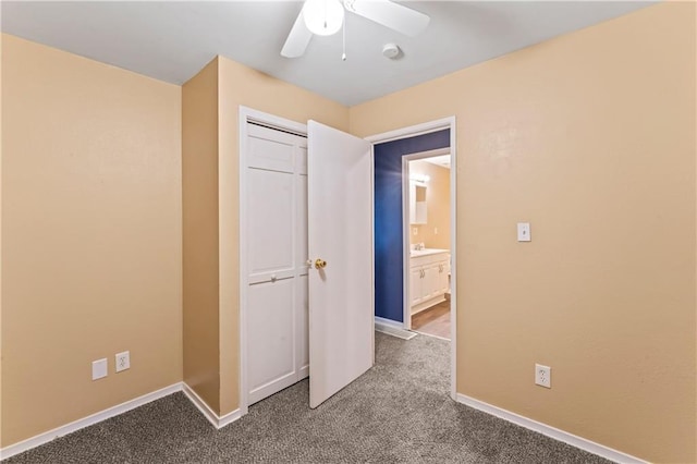 6418 E 150th St, Grandview, MO 64030 - unfurnished bedroom with dark colored carpet, baseboards, and a ceiling fan