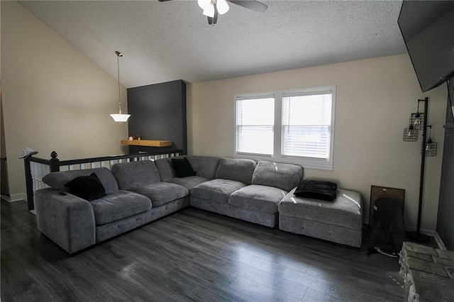 living room with dark wood finished floors, a textured ceiling, and lofted ceiling