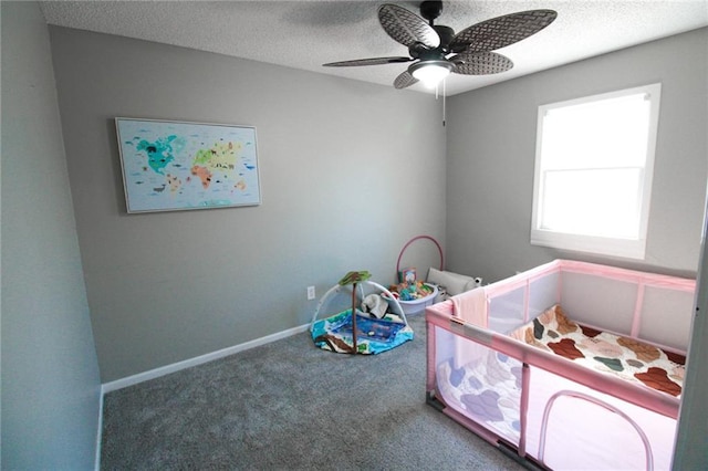 carpeted bedroom featuring baseboards, a textured ceiling, and ceiling fan