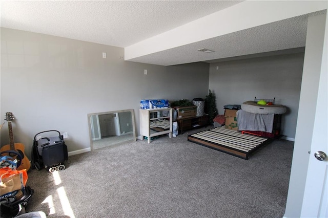 interior space with baseboards, a textured ceiling, and carpet