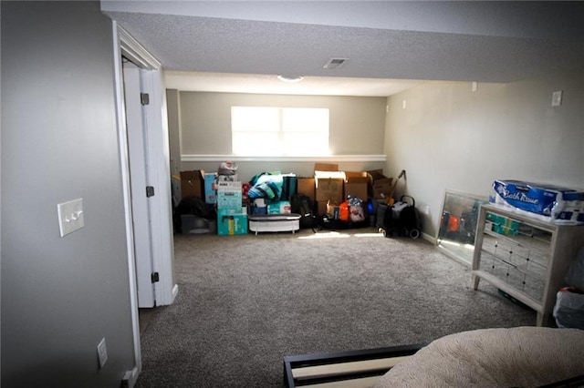 rec room featuring visible vents, a textured ceiling, and carpet floors