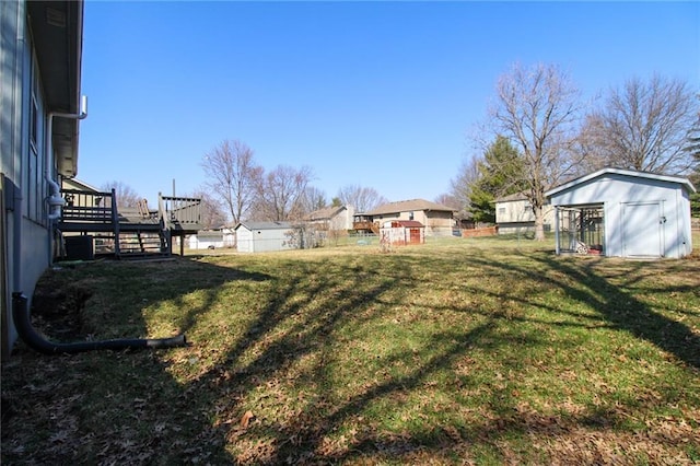 view of yard with a deck, an outbuilding, and a shed