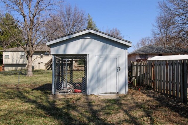 view of outdoor structure featuring an outbuilding and a fenced backyard