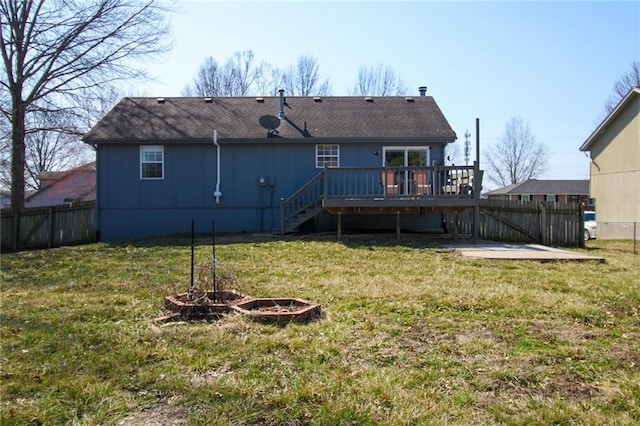 rear view of property with a lawn, a deck, fence, stairs, and a patio area