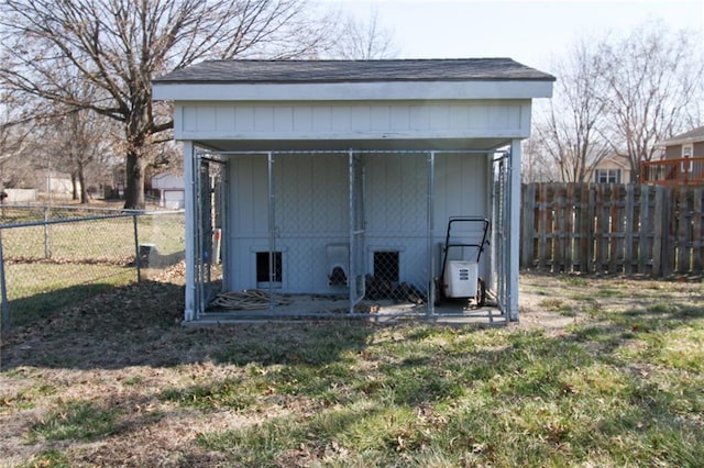 view of outbuilding featuring an outdoor structure and fence