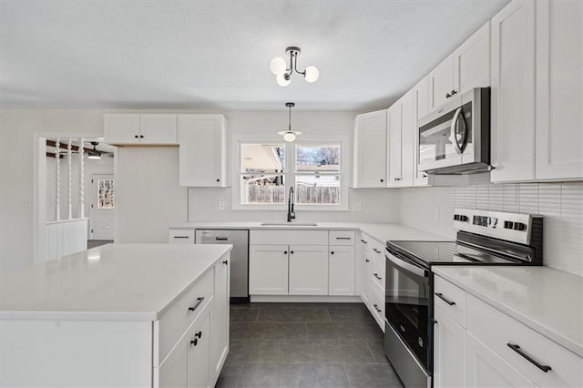 kitchen featuring white cabinets, appliances with stainless steel finishes, and a sink