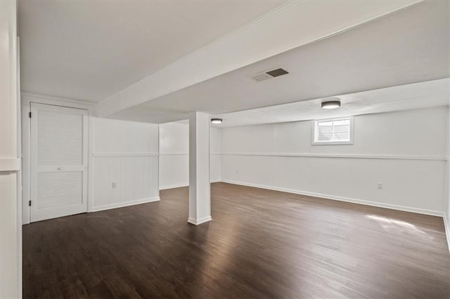 below grade area featuring visible vents, baseboards, and wood finished floors