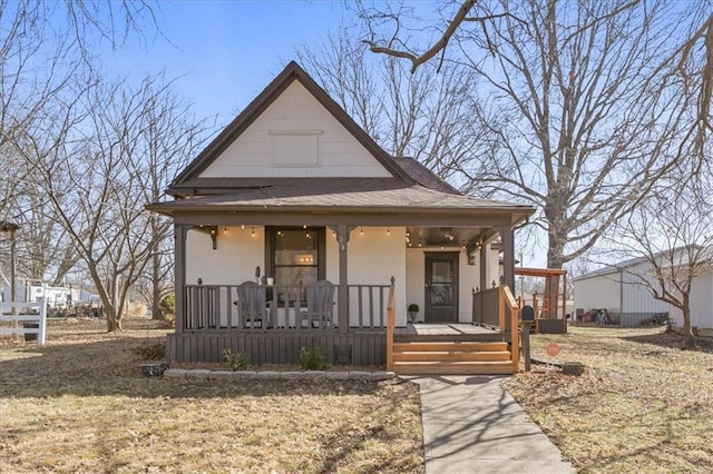 view of front of property with a porch and a shingled roof