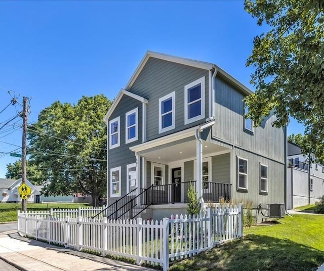 view of front of property with a fenced front yard, cooling unit, and covered porch