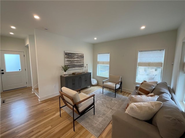 living area with light wood finished floors, baseboards, and recessed lighting