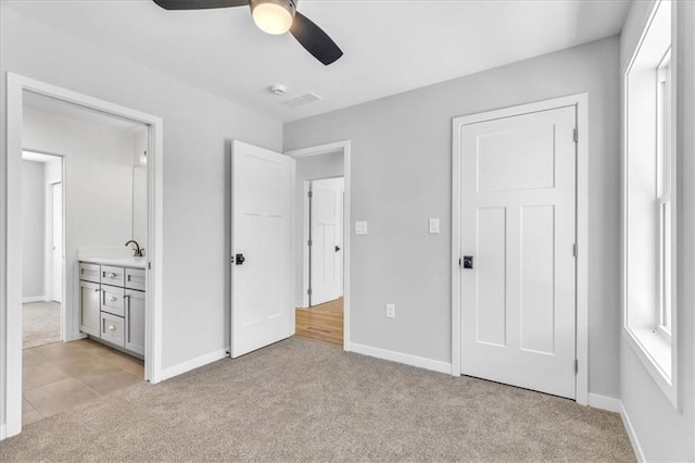 unfurnished bedroom with baseboards and light colored carpet