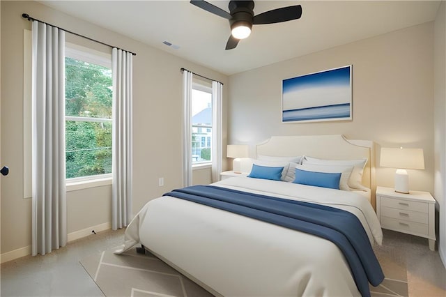 bedroom featuring light carpet, multiple windows, and visible vents