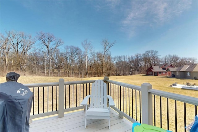 wooden deck featuring area for grilling and a yard