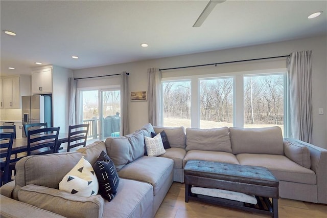 living area with a ceiling fan, recessed lighting, and light wood finished floors