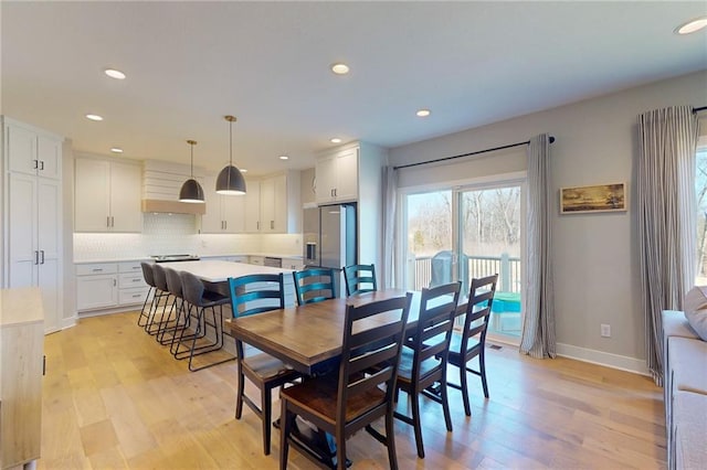 dining room with recessed lighting, baseboards, and light wood-type flooring