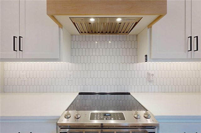 kitchen with custom exhaust hood, white cabinets, and light countertops