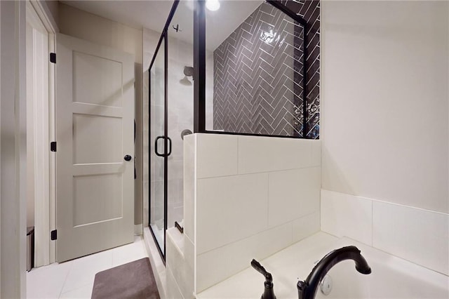 bathroom with tile patterned floors, a bath, and a shower stall