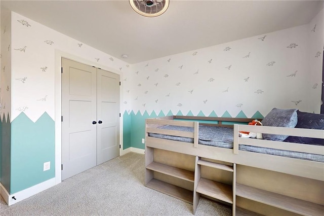 bedroom with carpet, visible vents, baseboards, wallpapered walls, and a closet