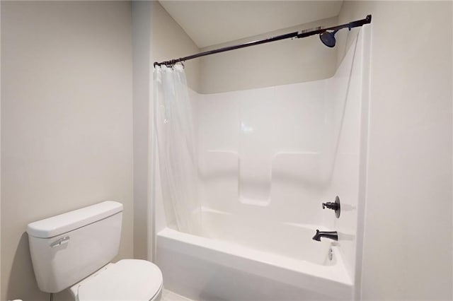 bathroom featuring toilet and shower / tub combo with curtain