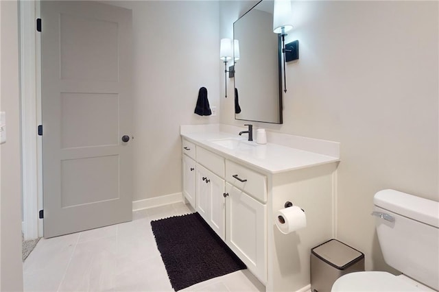 bathroom with tile patterned floors, toilet, vanity, and baseboards