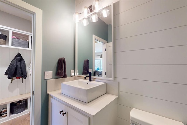 bathroom with vanity, toilet, and a chandelier