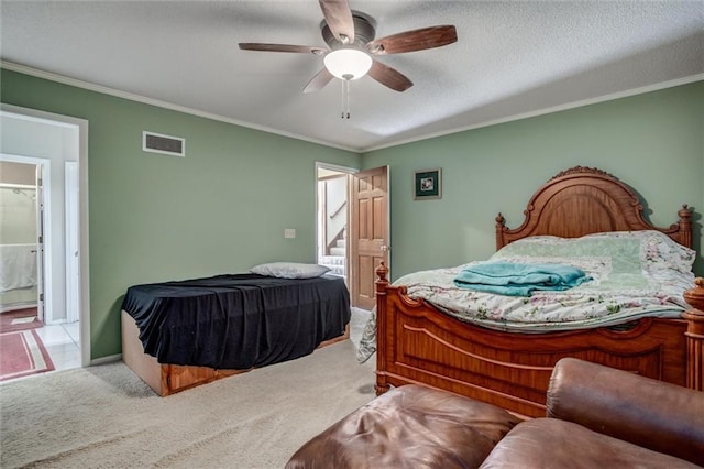 bedroom with visible vents, a textured ceiling, carpet flooring, and crown molding