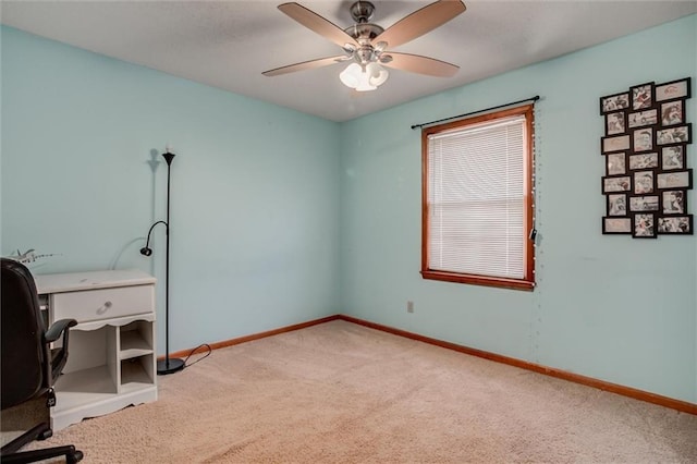 office area with light carpet, baseboards, and ceiling fan