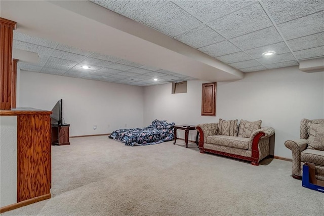 carpeted living area with recessed lighting, baseboards, and a paneled ceiling