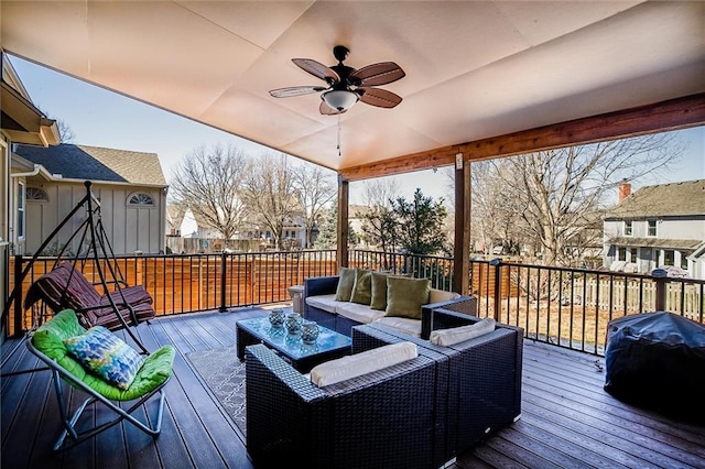 deck with grilling area, an outdoor hangout area, and ceiling fan