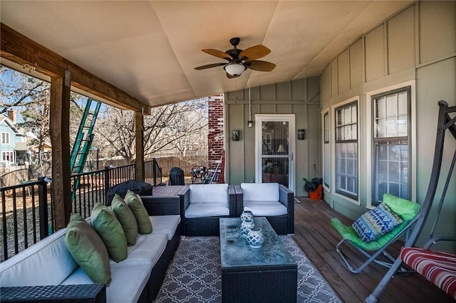 wooden terrace featuring an outdoor hangout area, a ceiling fan, and fence