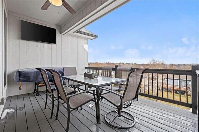 deck featuring outdoor dining area and a ceiling fan