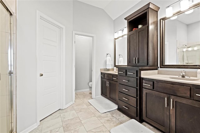 full bath featuring a stall shower, lofted ceiling, toilet, and vanity