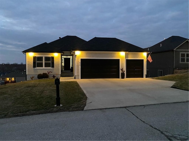 single story home featuring a garage, driveway, and a front yard