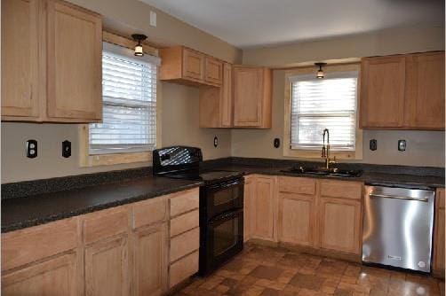 kitchen featuring dishwasher, range with two ovens, light brown cabinets, and a sink