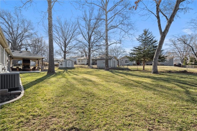 view of yard featuring a storage shed, an outdoor structure, and cooling unit