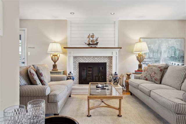 living room featuring a tiled fireplace and recessed lighting