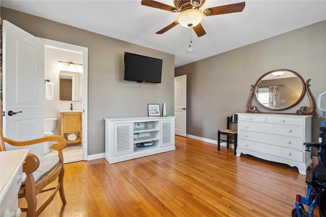 sitting room featuring light wood finished floors, ceiling fan, and baseboards