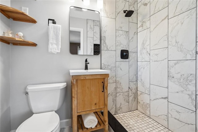 full bath featuring tiled shower, toilet, and vanity