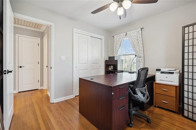 office with a ceiling fan, baseboards, and wood finished floors