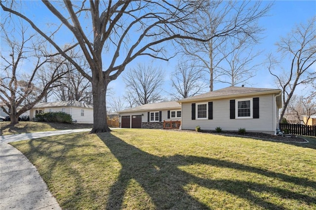 view of front facade with a garage, driveway, a front yard, and fence