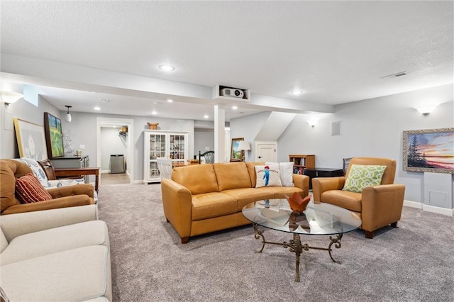 carpeted living room with visible vents, recessed lighting, baseboards, and a textured ceiling