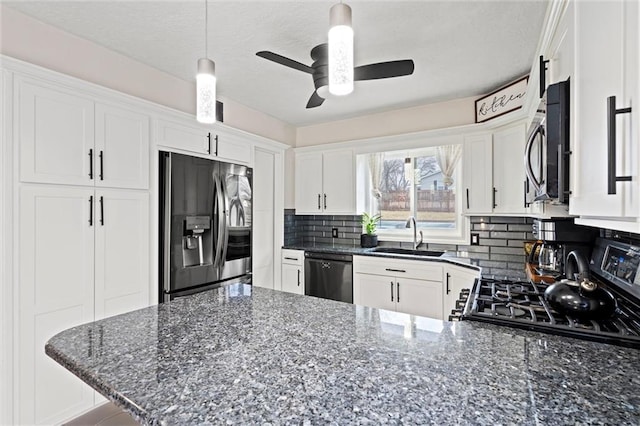 kitchen with a sink, stainless steel appliances, tasteful backsplash, and white cabinets