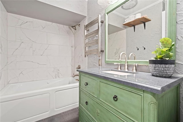 full bathroom with vanity, shower / bathing tub combination, and a textured wall