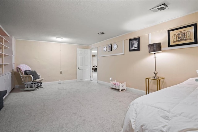 carpeted bedroom featuring visible vents, baseboards, and a textured ceiling