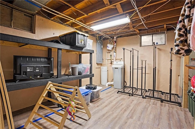 unfinished basement featuring electric panel and wood finished floors