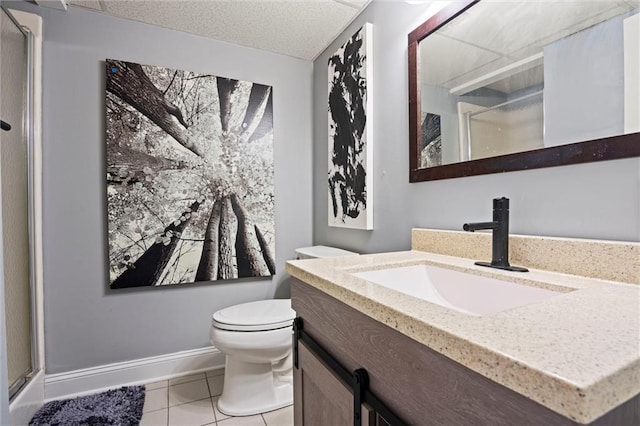 full bathroom featuring tile patterned flooring, a shower stall, toilet, and vanity