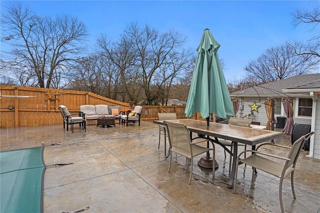 view of patio featuring outdoor lounge area, outdoor dining space, and a fenced backyard