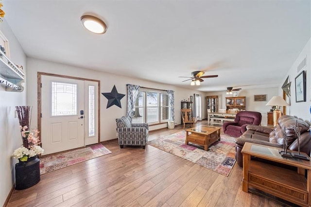 living room featuring light wood-style floors and visible vents