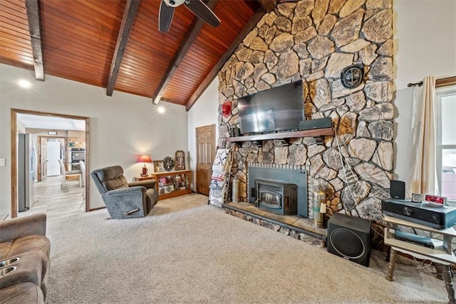 living room with carpet, beamed ceiling, wood ceiling, a wood stove, and high vaulted ceiling