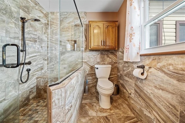 full bath featuring a stall shower, toilet, and tile walls